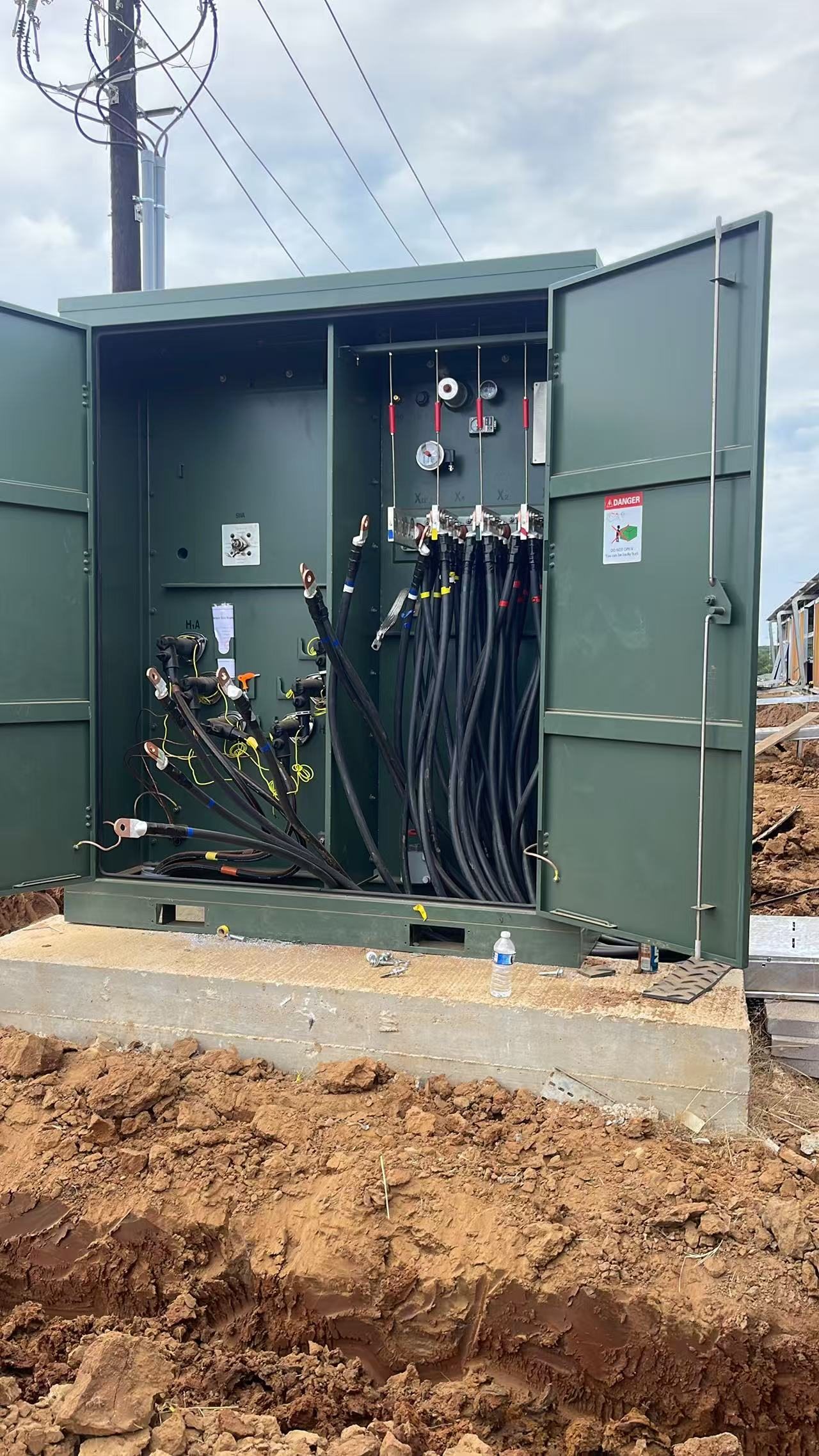 Open transformer cabinet used to review equipment condition, missing material, utility status, and owner decisions