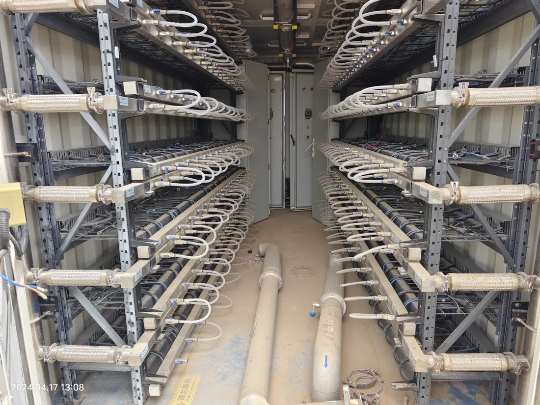 Rack corridor service access showing field maintenance conditions inside a high-density equipment environment