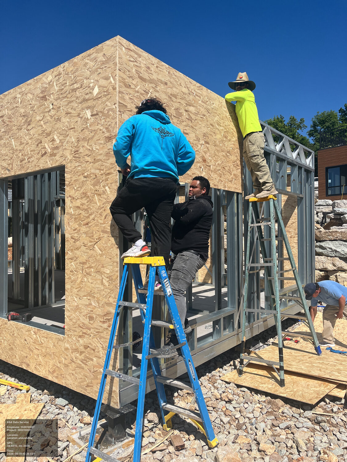 Residential wall enclosure being applied over steel framing