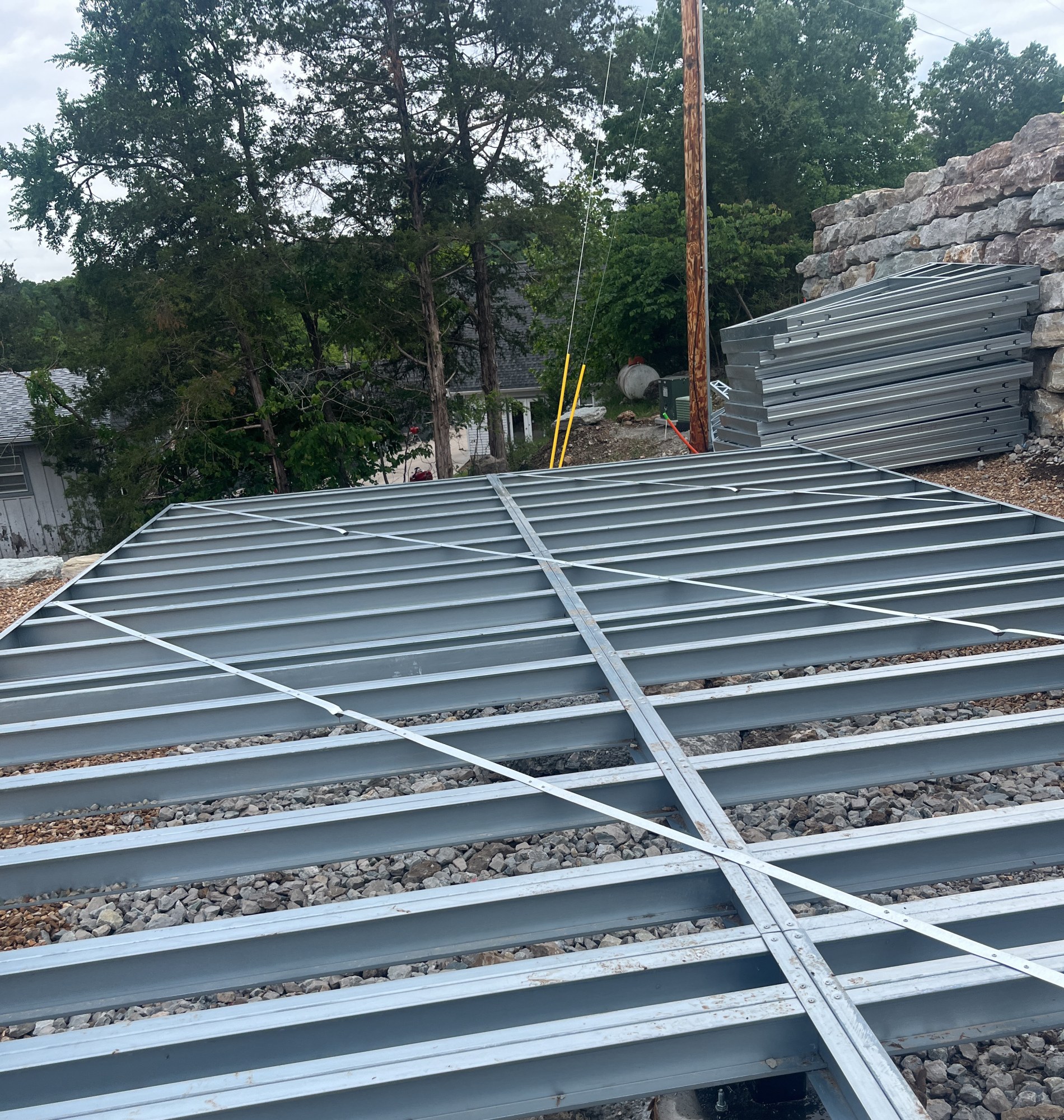 Pier base plate with anchor bolts and levelling shims under the steel floor structure, 6 May 2026